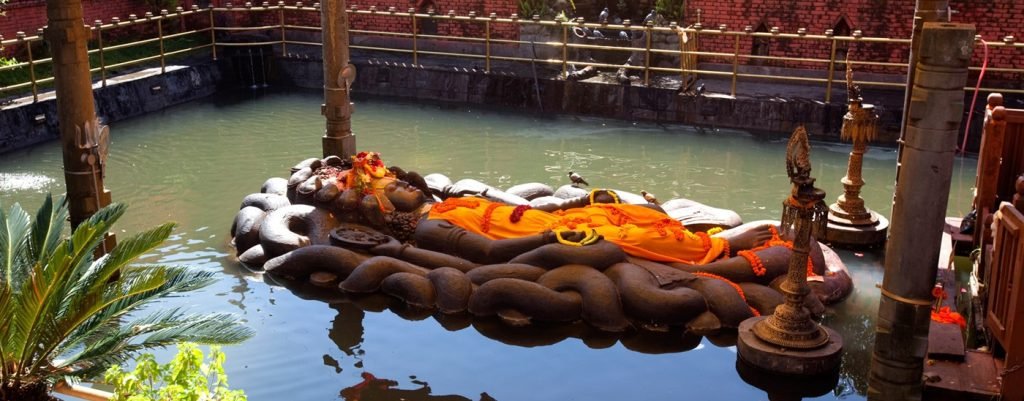 Budhanilkantha Temple tour package by NAMO Nepal Trip, featuring the ancient Hindu temple with a reclining statue of Lord Vishnu in Kathmandu.